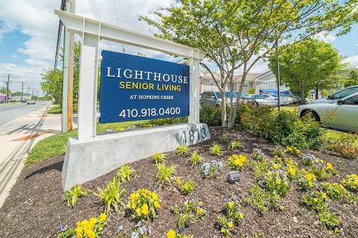 Welcome sign for Lighthouse Senior Living, surrounded by well-maintained landscaping.