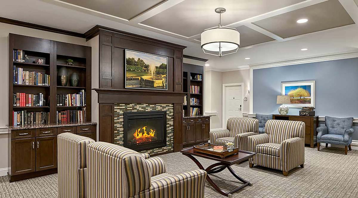 A cozy living room with a fireplace and elegant furnishings.