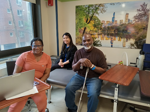 A warm moment shared among three individuals in a healthcare facility, capturing smiles and connection.
