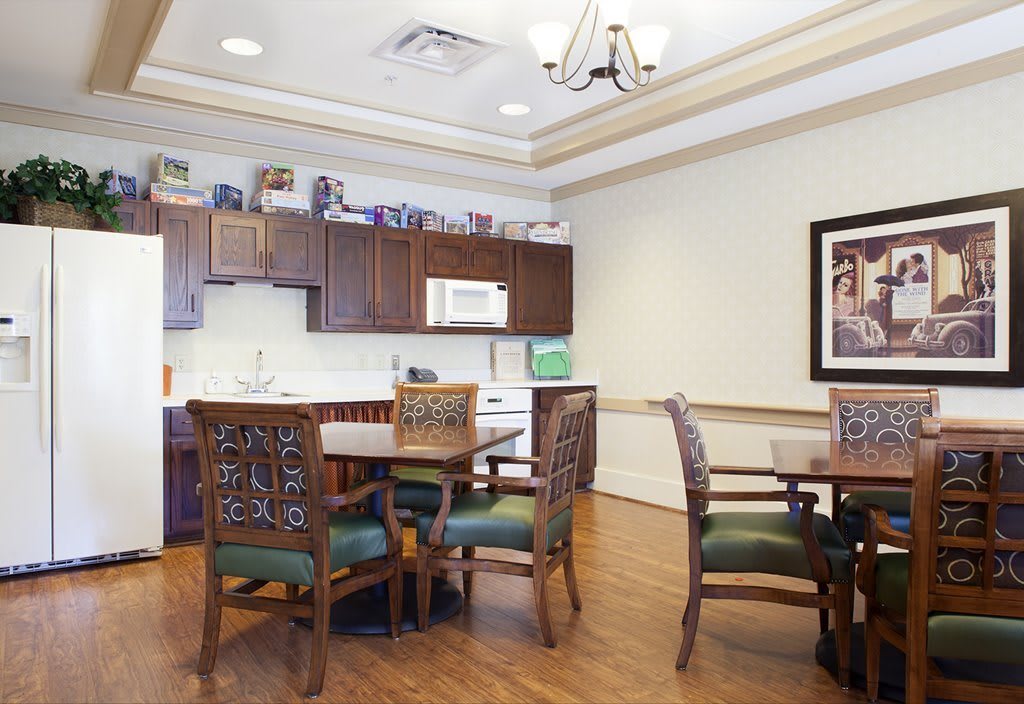 A cozy kitchen and dining area with wooden furniture and cabinets.