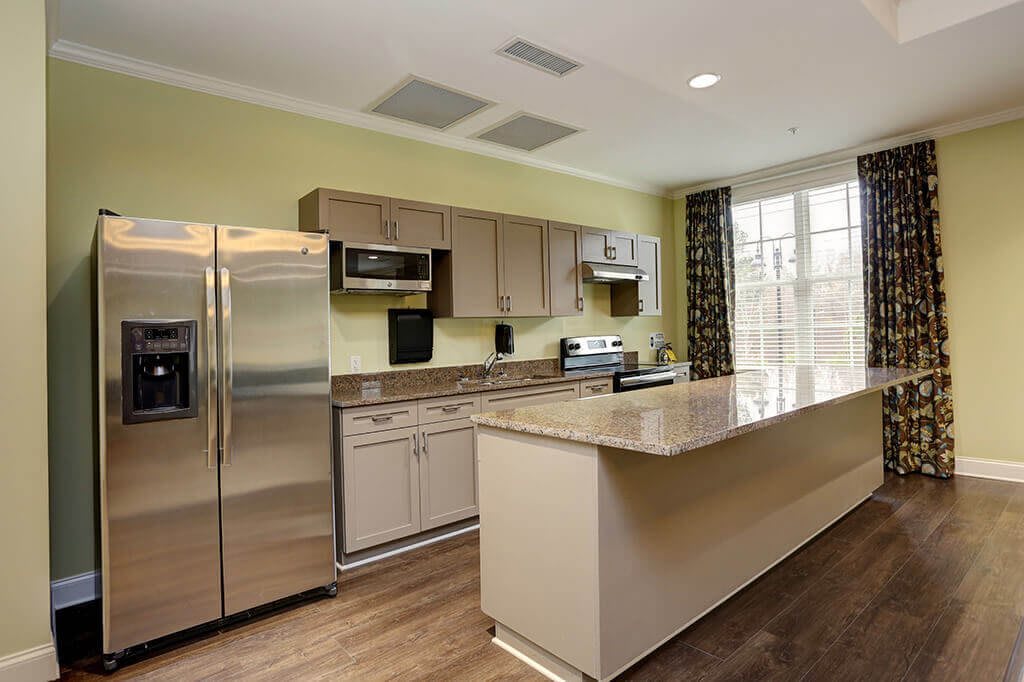 A modern kitchen with stainless steel appliances and a spacious countertop.