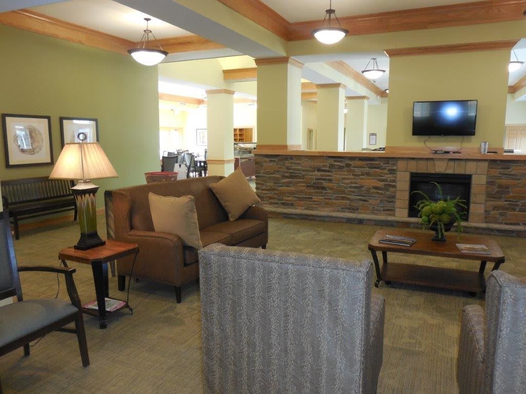 A cozy living room with comfortable seating and a fireplace.