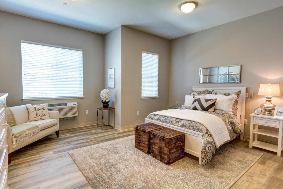 A cozy bedroom with modern decor and abundant natural light.