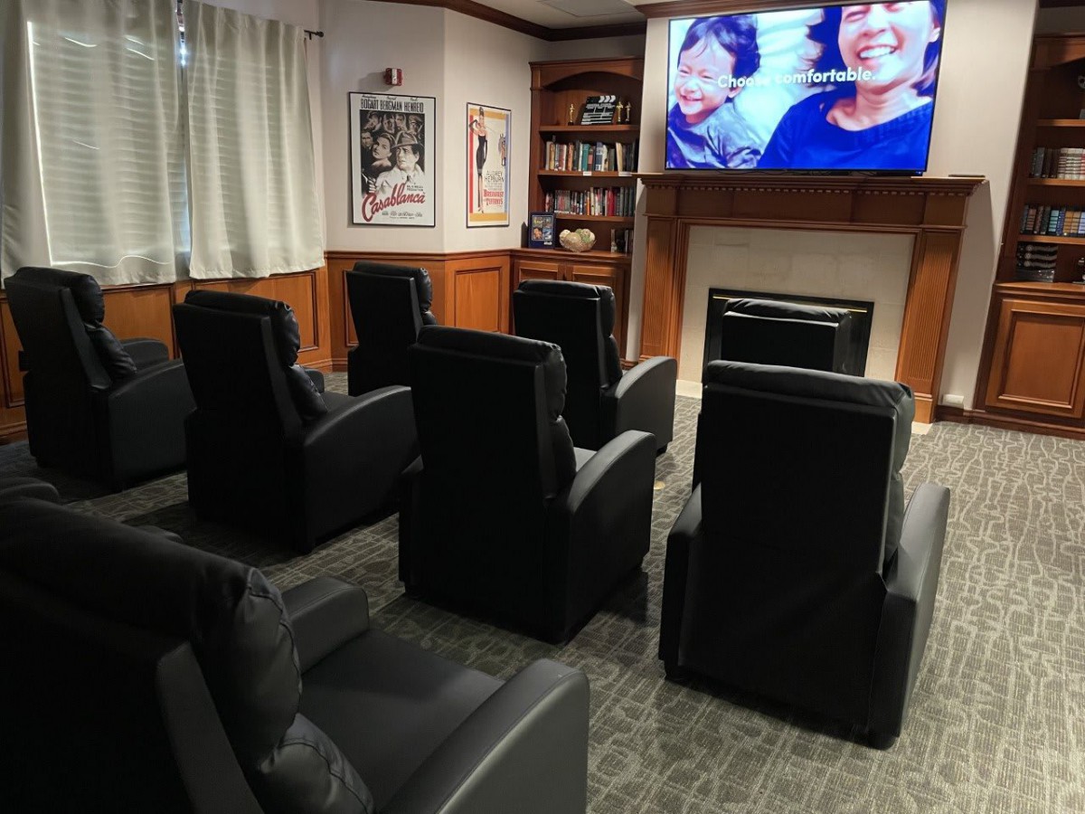 A cozy home theater setup with comfortable seating and a large screen.