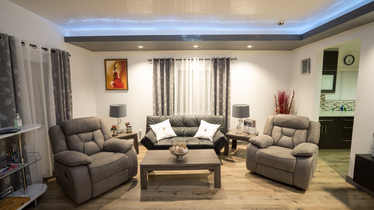 A modern living room with a comfortable sofa set and stylish decor.