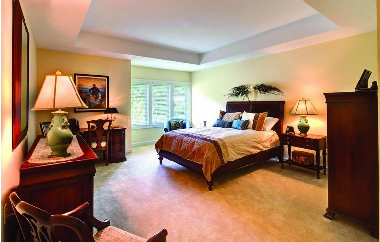 A cozy and well-decorated bedroom with soft lighting and elegant furnishings.