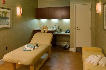 A calming spa therapy room with a massage table and soothing ambiance.