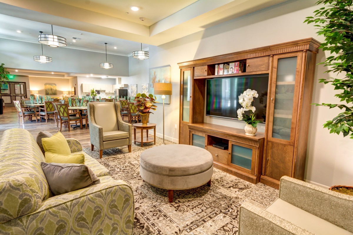 A cozy living room with a wooden entertainment center and comfortable seating.