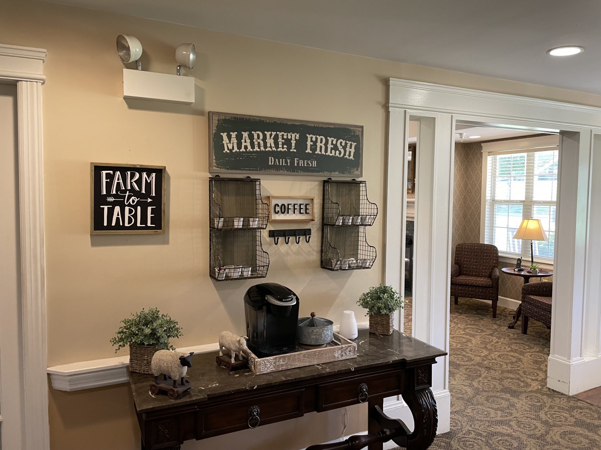 A cozy coffee nook with rustic farmhouse decor and wall art.
