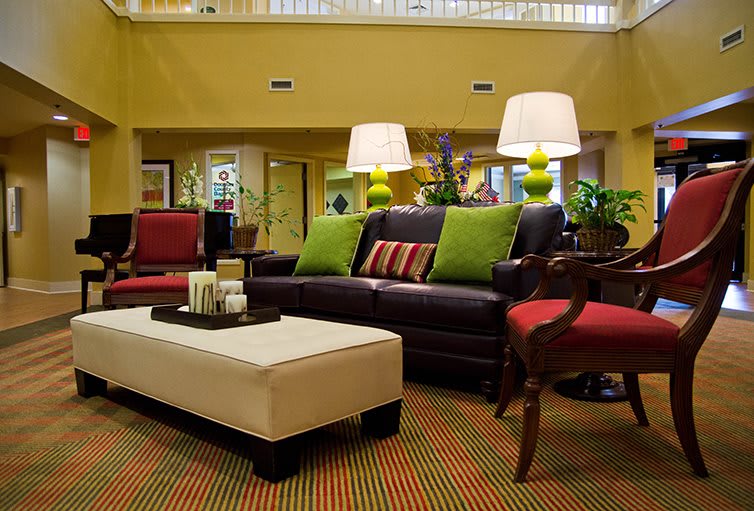 A stylish living room with a modern sofa, colorful pillows, and elegant lamps.