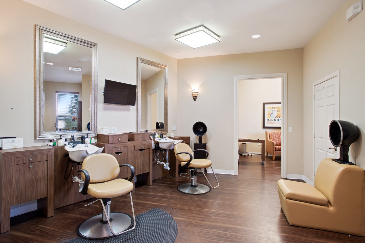 A modern hair salon interior with styling chairs and mirrors.