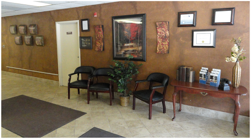 A welcoming waiting area featuring comfortable chairs and decorative artwork.