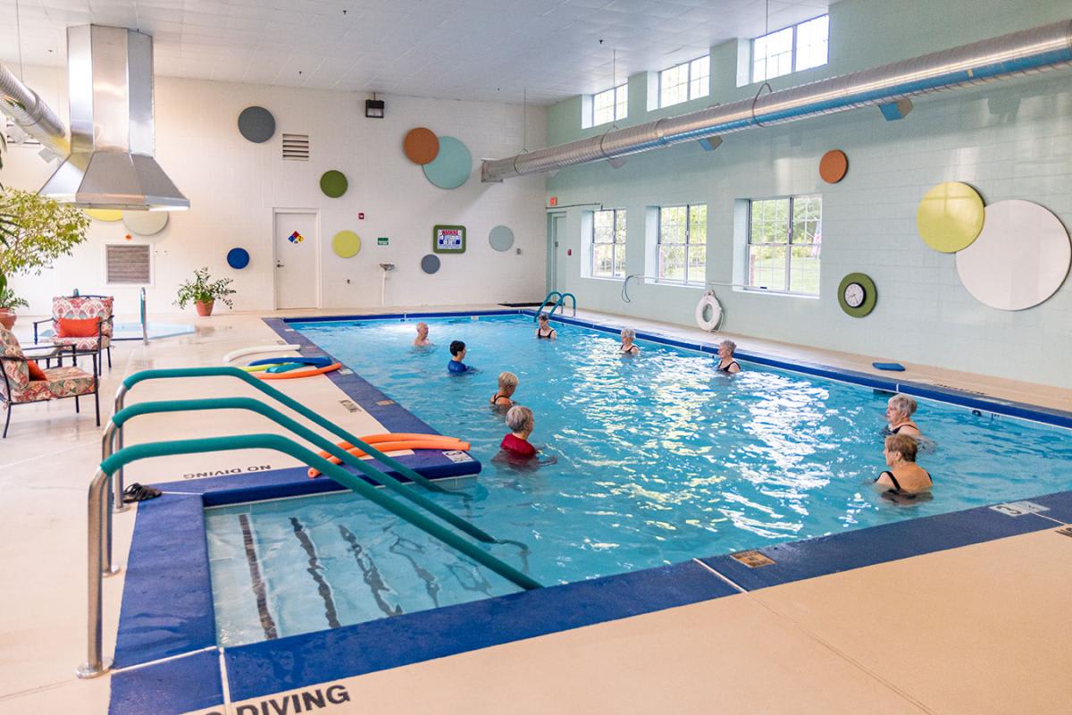 Children enjoy swimming and playing in an indoor pool.