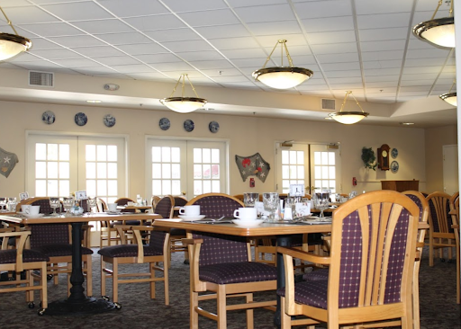 A spacious dining area set up with tables and chairs, ready for guests.