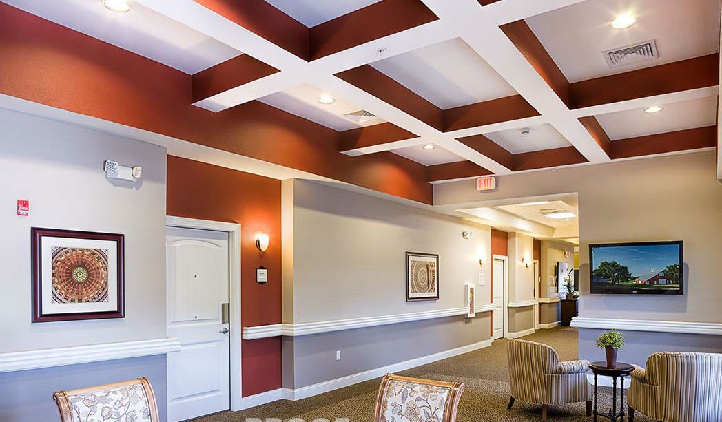Spacious lobby area with modern ceiling design and comfortable seating.