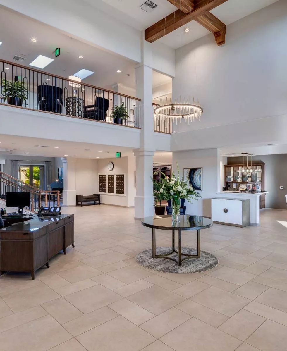 A spacious and modern lobby featuring elegant furniture and stylish lighting.