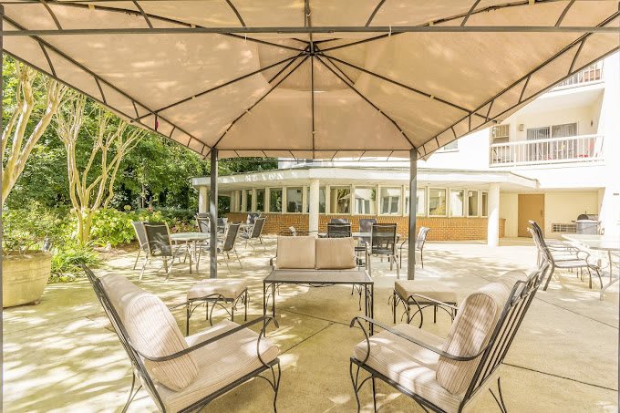 Outdoor patio area with comfortable seating under a canopy.
