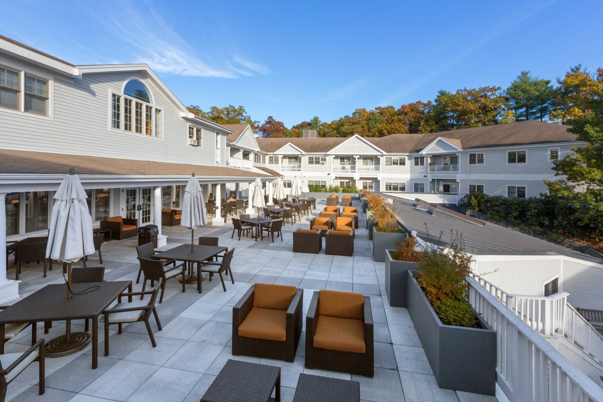 Elegant outdoor patio area at a resort with comfortable seating and scenic surroundings.