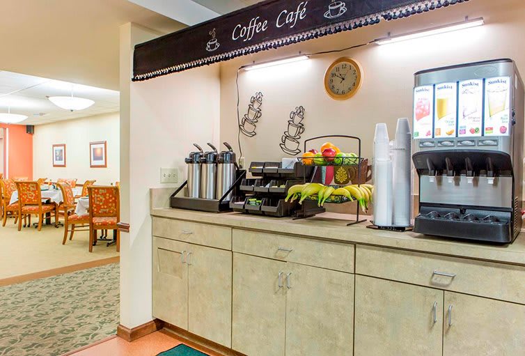 A self-service coffee station with multiple beverage dispensers and a cozy, welcoming setup.