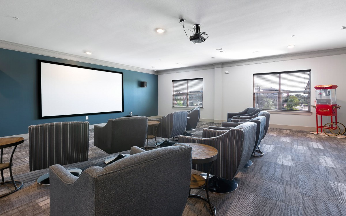 Modern home theater with comfortable seating and a large screen.