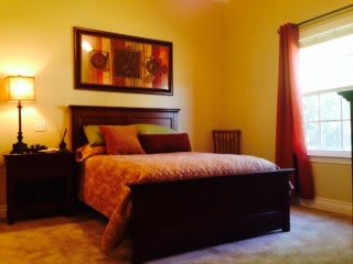 A cozy bedroom with warm lighting and elegant decor.