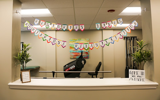 A vibrant office space decorated with a colorful banner and exercise equipment in the background.