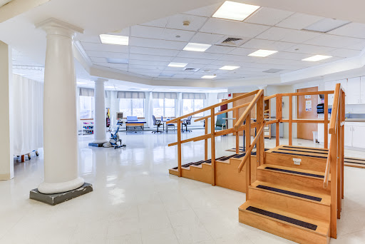 An inviting physical therapy space equipped with stairs and various exercise equipment for rehabilitation.