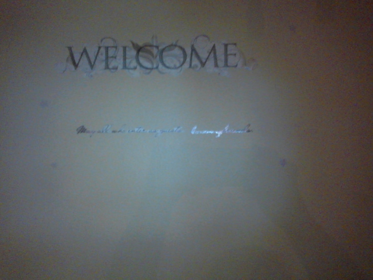 A warmly lit wall with a 'Welcome' decoration.