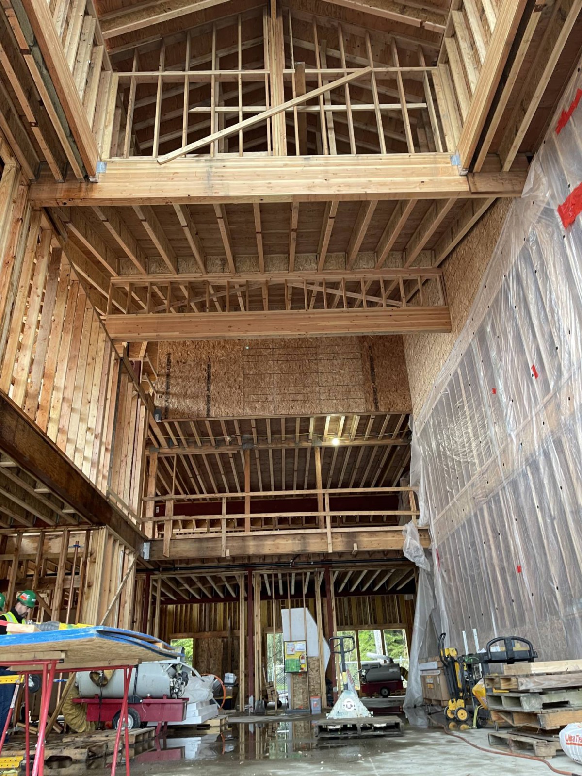 Interior view of a building under construction with wooden framing.