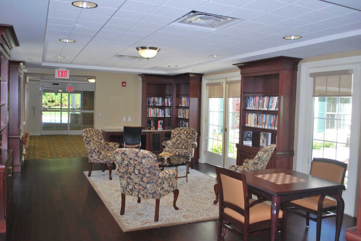 A cozy library with bookshelves and comfortable seating for reading.
