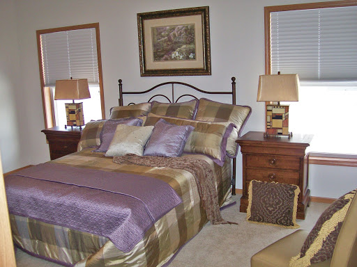 A beautifully decorated bedroom featuring elegant bedding and tasteful decor.