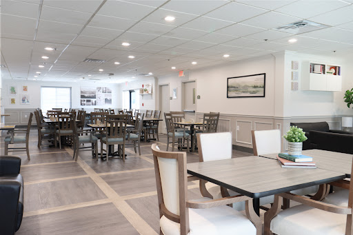 A well-lit and spacious dining area featuring modern furniture.