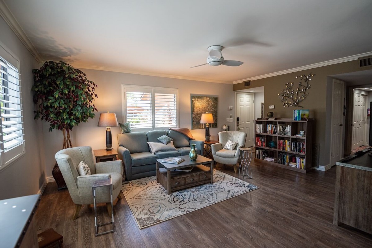 A cozy living room with comfortable seating, a bookshelf, and stylish decor.