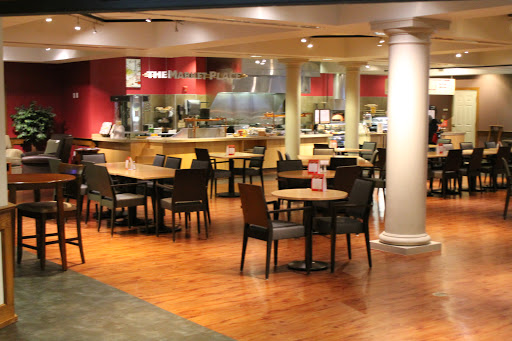 A spacious and inviting restaurant interior, featuring tables and chairs arranged for casual dining.