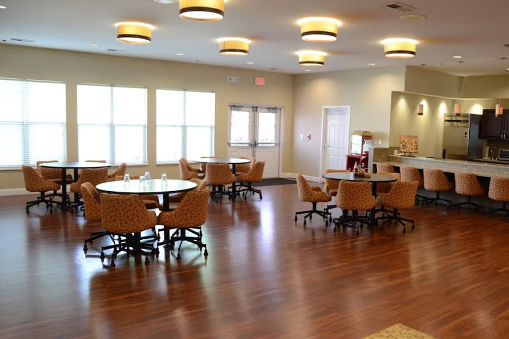 Spacious dining area with wooden floors and ample lighting.