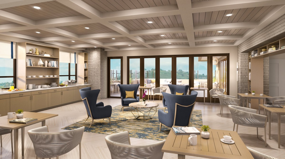 A modern lounge area with stylish seating and large windows allowing abundant natural light.