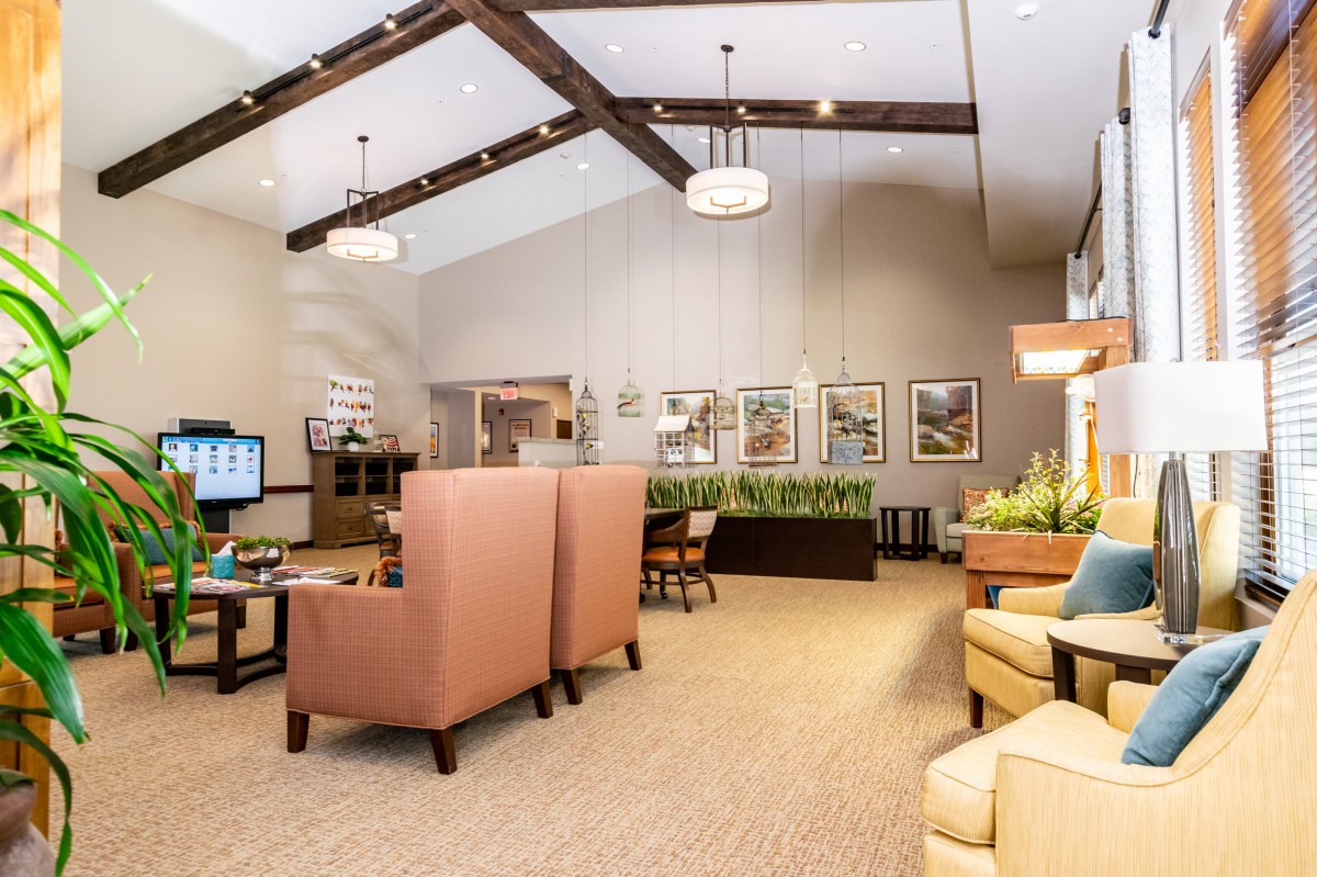 A modern lobby interior with comfortable seating, stylish lighting, and decorative plants.