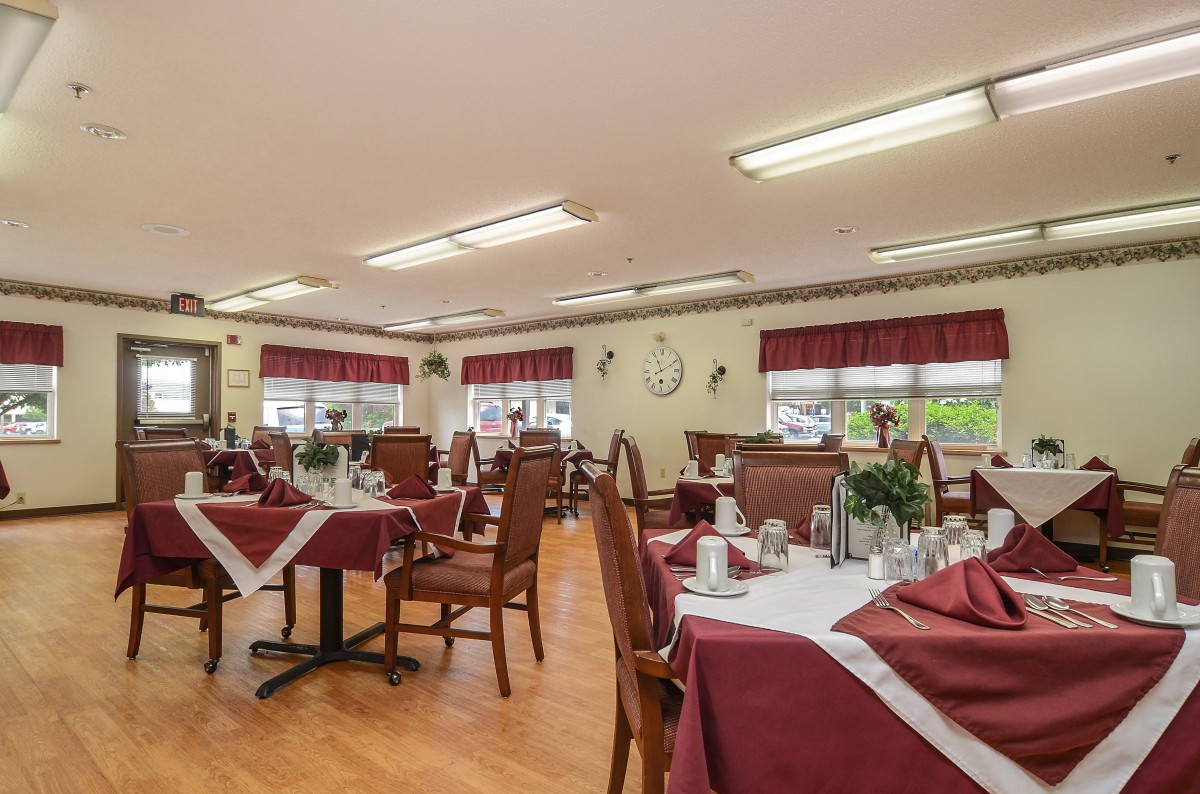 A well-decorated dining area with tables and chairs neatly arranged.