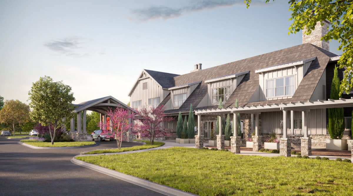 A charming residential house with a lush garden and blooming trees.