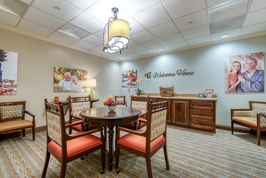 A cozy dining area with a round table, chairs, and decorative lighting.