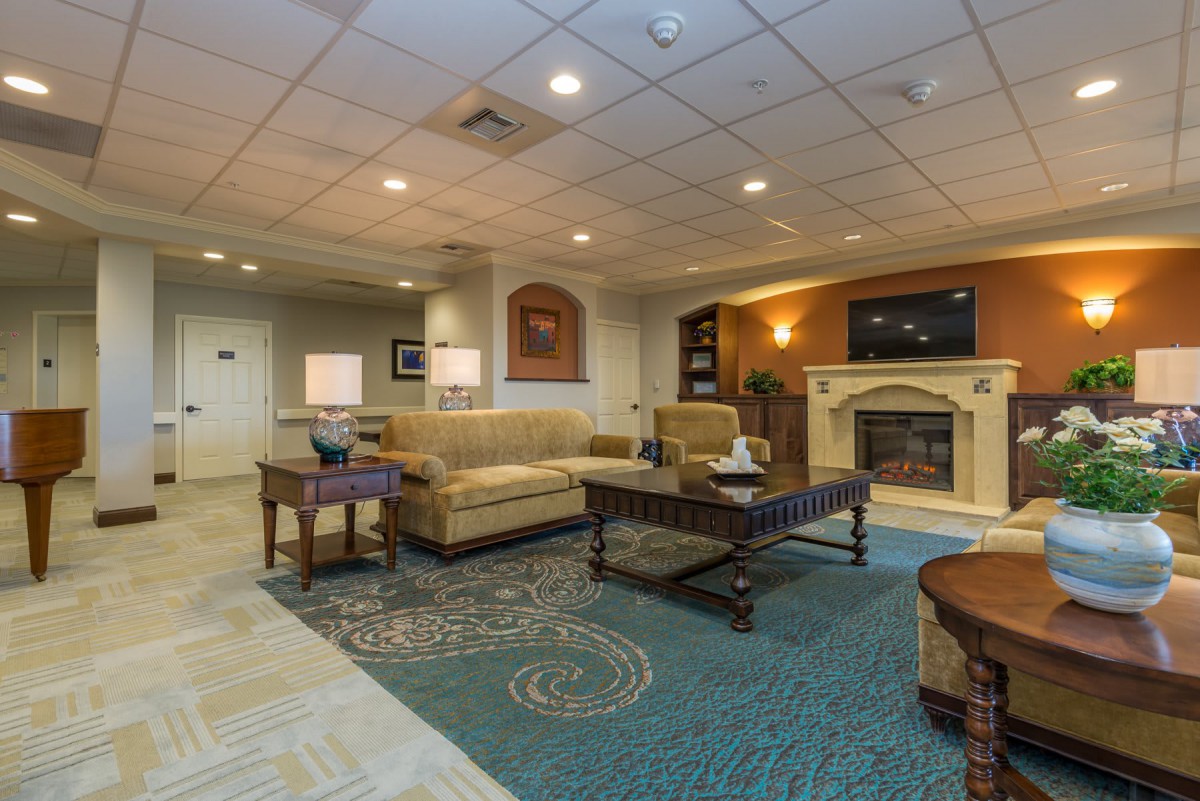 A cozy hotel lobby with comfortable seating and a fireplace.