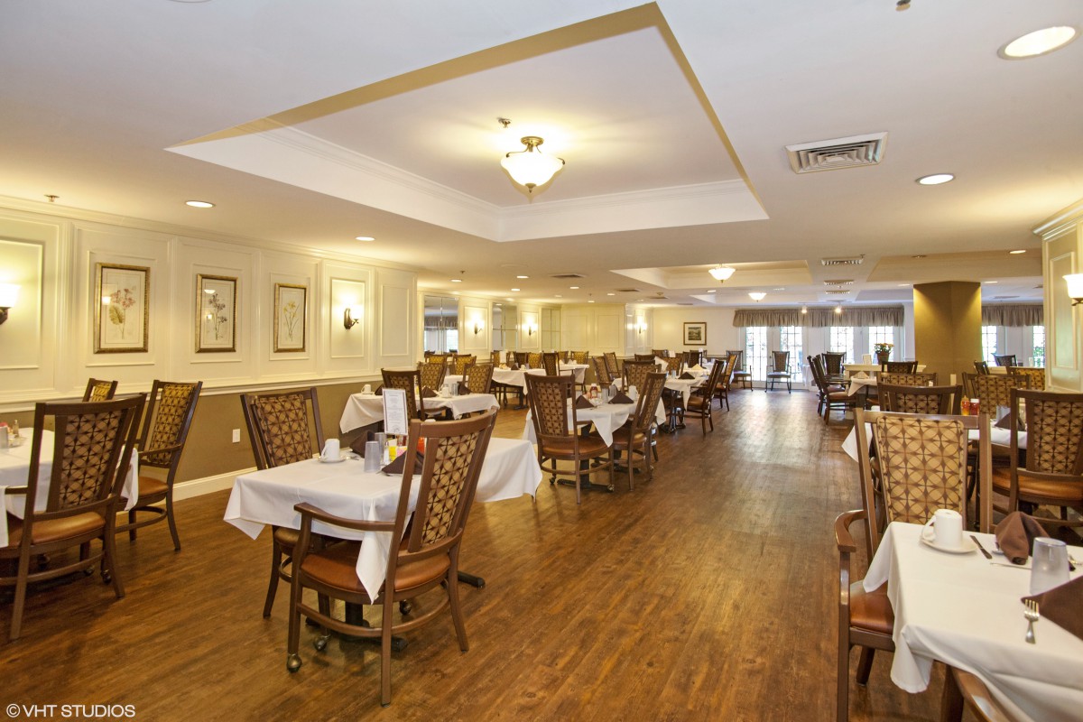 Elegant dining room with neatly arranged tables and chairs.