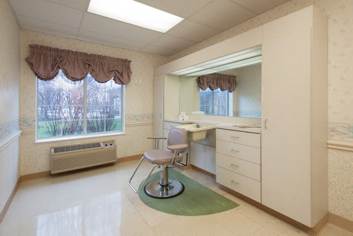 A well-lit salon space featuring a vanity, mirror, and styling chair.