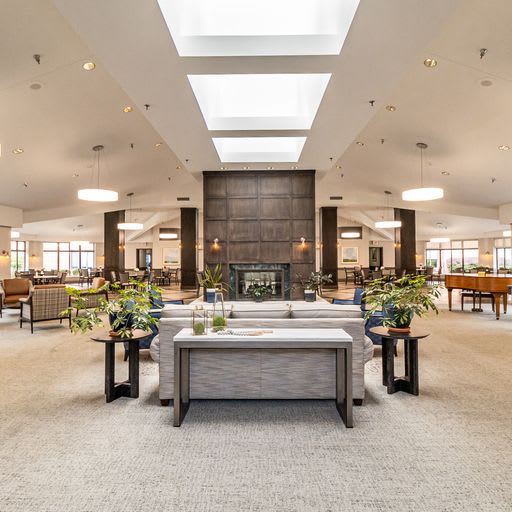 A spacious and modern lobby interior with elegant furniture and natural lighting.
