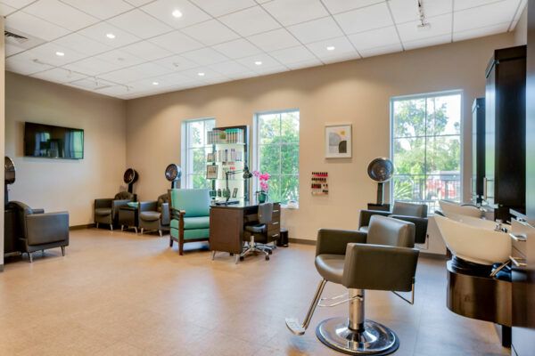 A modern hair salon with stylish chairs and equipment.