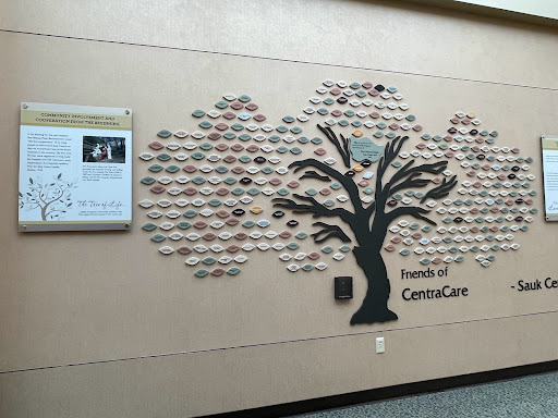 A decorative wall display featuring a tree made of ceramic pieces, representing the Friends of CancerCare.
