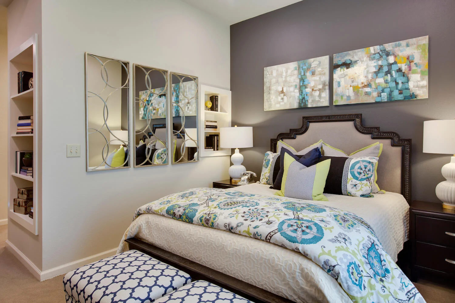 A stylish and modern bedroom with decorative bedding and artwork.