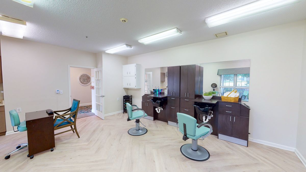 A bright and clean hair salon interior with chairs and mirrors.