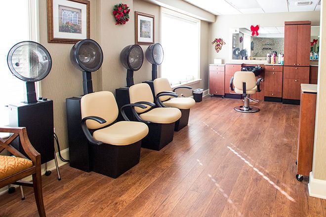 A cozy salon interior with hair dryers and a waiting area.