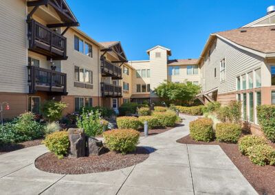 A sunny day in the courtyard of a residential apartment complex with well-maintained landscaping.